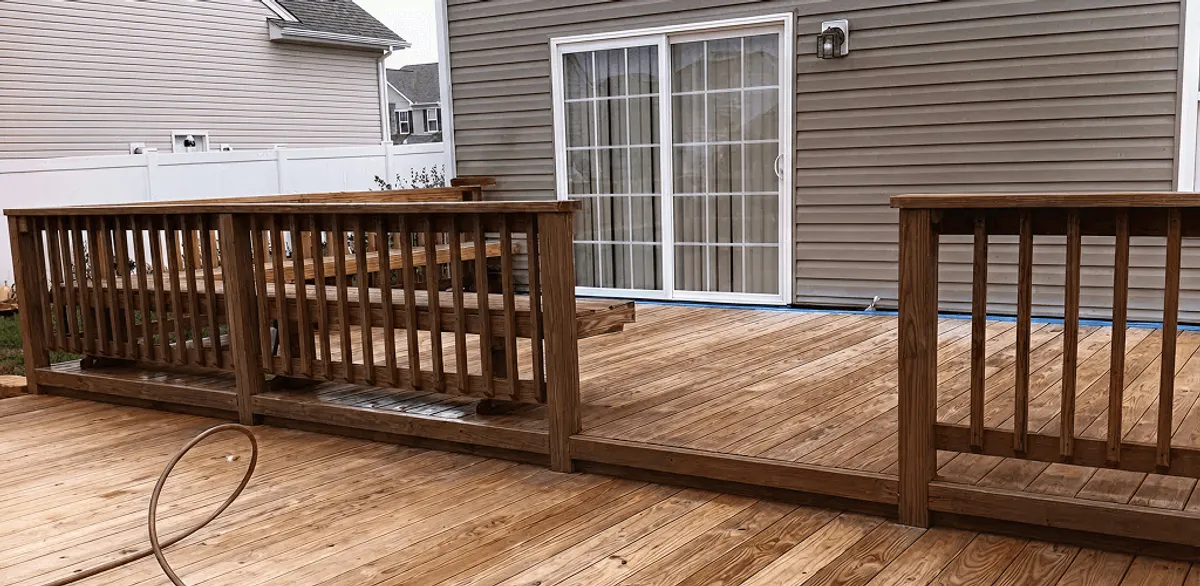 Deck sealing service protecting a backyard wood deck and railings in Tempe, AZ