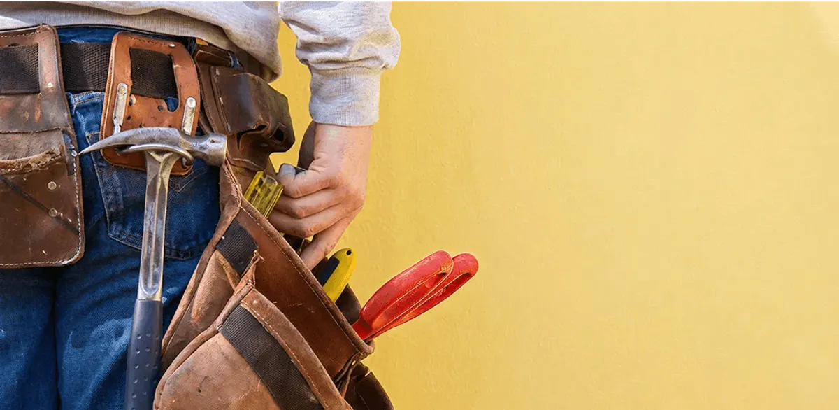 Handyman with tool belt ready for home repairs and maintenance in Tempe, AZ