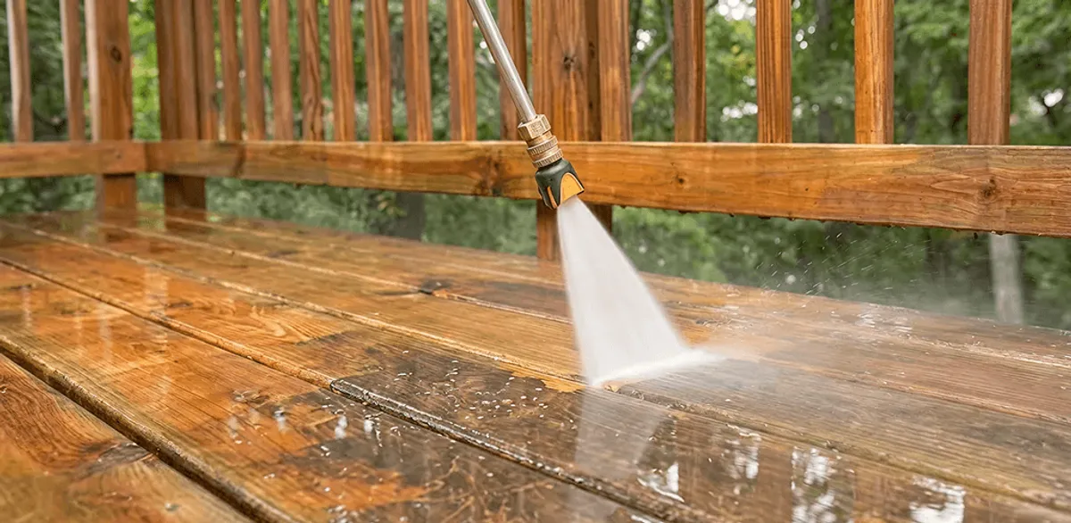 Pressure washing a wood deck to remove dirt and buildup in Tempe, AZ